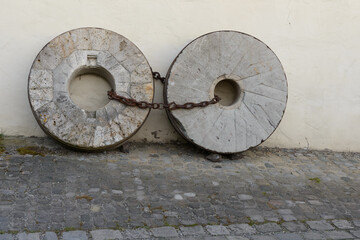 Two millstones chained together