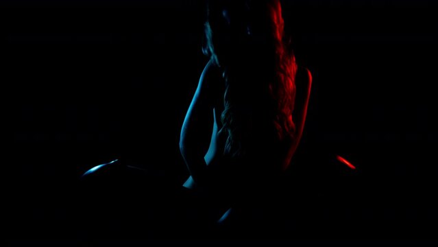 Female dancer posing against colourful background