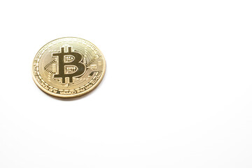 a bit coin on a white background, with copy space, golden cryptocurrency