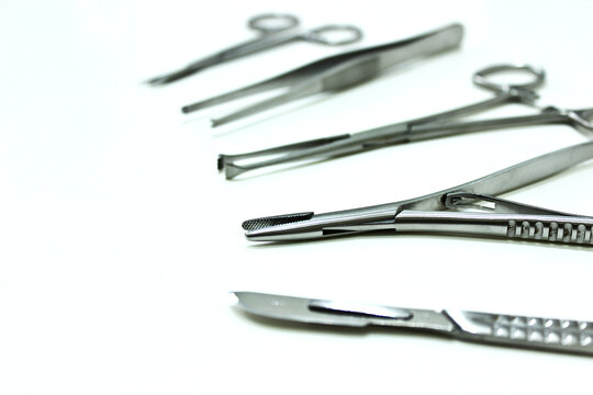 Surgical instruments isolated on the white background, focus on needle holder