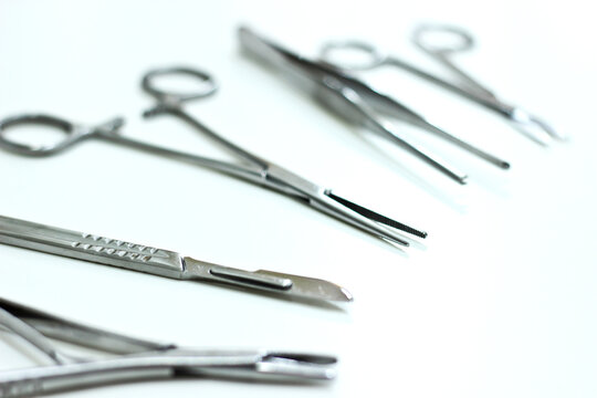 Surgical instruments isolated on the white background, focus on the scalpel blade