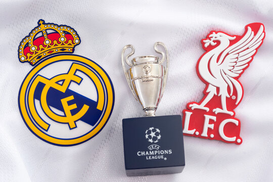Croydon, UK - May 24, 2020: illustrative editorial of replica of the Champions league trophy, the emblem of Real Madrid and the badge of Liverpool (the teams that compete in the tournament final)