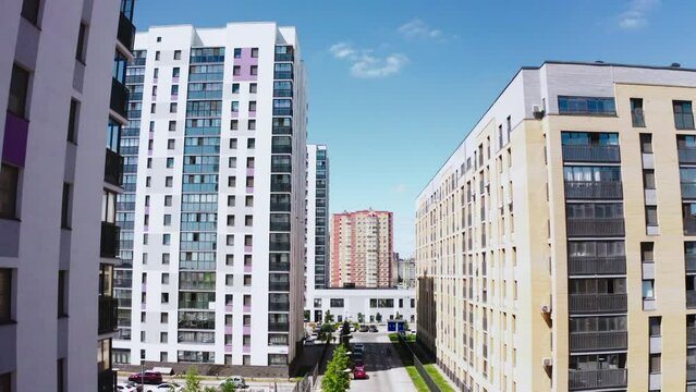 Contemporary residential buildings in the city. Stock footage. Exterior of a modern design of multistorey apartment buildings, aerial view.