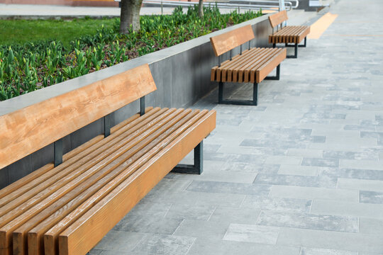 Paved city street with comfortable wooden benches