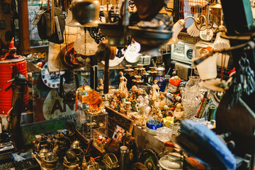 antiques in the vintage shop: art, toy cars, lantern lamps, sculpture, miniatures, old cameras,...