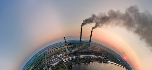 Aerial view from high altitude of little planet earth with coal power plant high pipes with black...