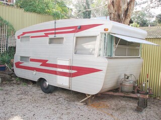 Vintage 1970's silver Caravan trailer on holiday camping site 