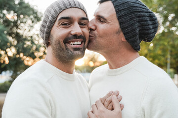 Mature gay men couple having tender moment outdoor - Focus on left man face