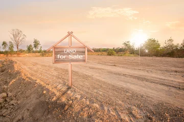 Foto op Canvas Land sales sign, land plot for housing construction project with car tire print in rural area and real estate sale or property investment concept, © Gan