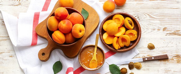 Tasty ripe apricots with sweet jam on table