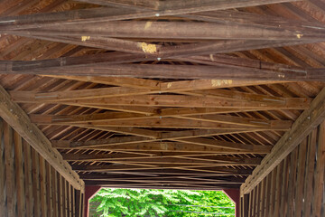 Fototapeta na wymiar View of a Covered Bridge's Timber Frame Construction on a Cloudy Day