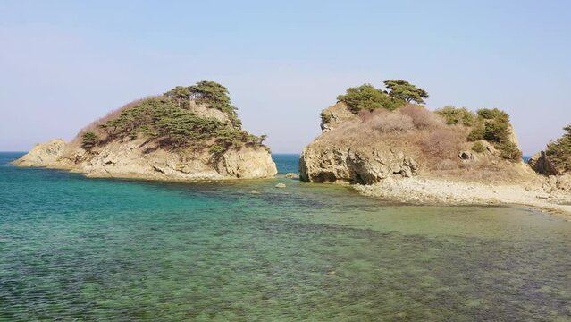 Aerial view of a rocky promontory with a strait between the rocks. Beautiful bay Orlinka (Warm) with clean and clear water. Marine reserve. Untouched nature.