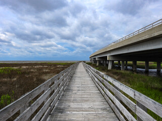 Old Wooden Pier Next to a Highway Bridge Over the River