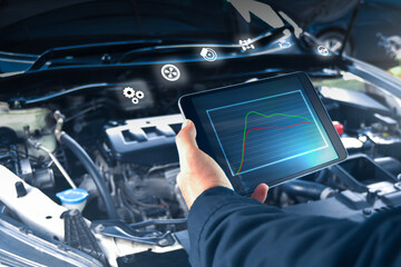 Auto mechanic is checking engine system with a ODB2 tablet and auto service icon,auto repair shop business concept
