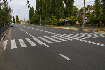 Pedestrian crossing on asphalt road in city