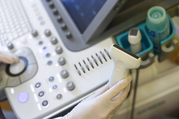 Doctor using ultrasound machine in clinic, closeup