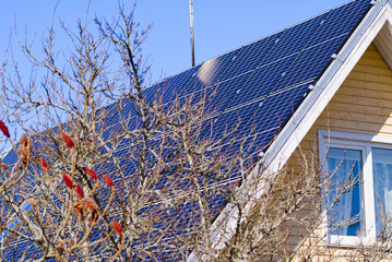 Solar Panels on roof own home. Single family house with solar system or photovoltaic system.