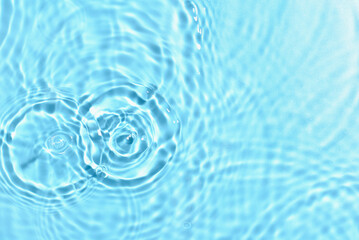 Texture of water with ripples on blue background, closeup