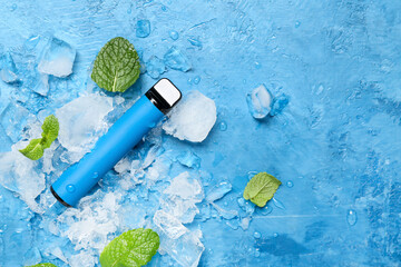 Disposable electronic cigarette, mint and ice cubes on blue background