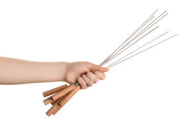 Female hand with wooden skewers on white background