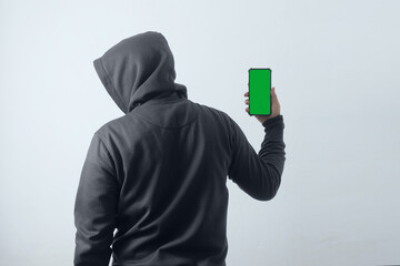 mysterious man wearing hoodie and holding phone