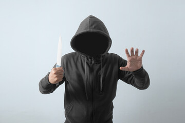 front view faceless man holding knife