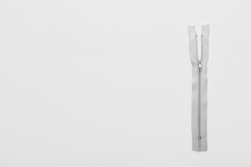 Stylish grey zipper on white background © Pixel-Shot