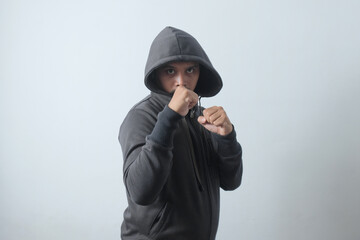 front view of hooded man with fighting stance