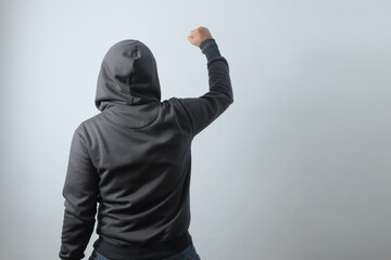rear view mysterious man clenched fist, demonstration illustration