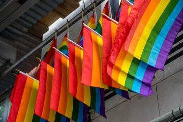 New York, NY - USA - May 20 2022 Closeup of a line of Rainbow flags hung above The Stonewall Inn. Gay bar & National Historic Landmark, site of the 1969 riots that launched the gay rights movement.