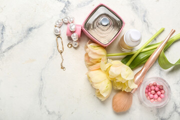 Bouquet of tulips and female accessories on light background