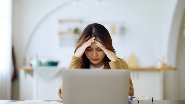 Office syndrome concept. Overworked tired young asian woman feeling headache, having eyesight problem after computer laptop work. Stressed adult business woman suffering from fatigue at home