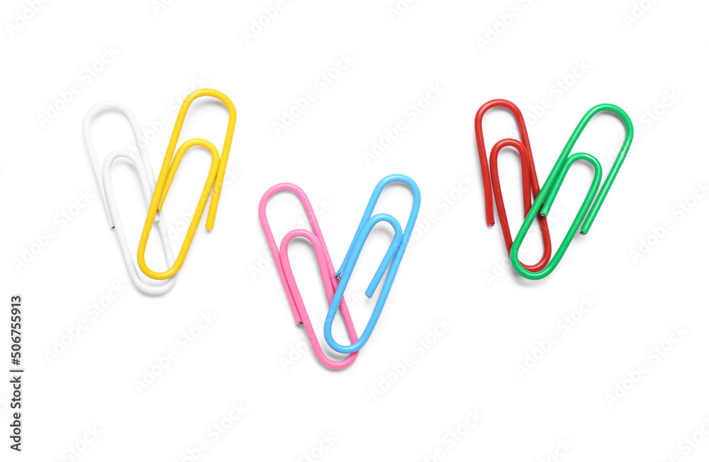 Wall mural Colorful paper clips on white background, top view