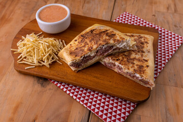 Swiss crepe stuffed with jerky and cream cheese, rosé sauce and potato sticks