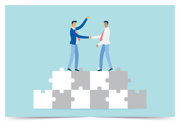 Businessmen shaking hands on a puzzle