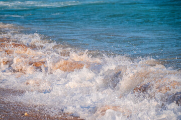 Soft wave of the sea on the sandy beach.