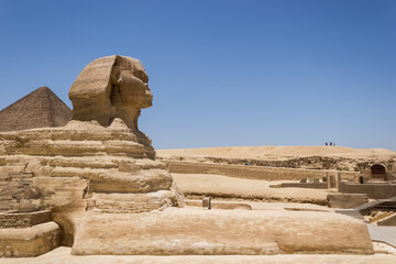 Architectural detail of the Giza pyramid complex with the Great Sphinx of Giza in the foreground...