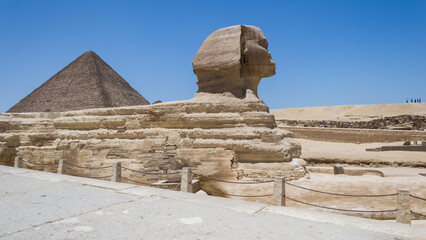 Architectural detail of the Giza pyramid complex with the Great Sphinx of Giza in the foreground...