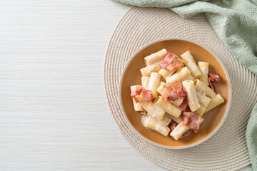 spaghetti rigatoni pasta with white sauce and bacon