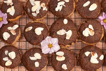 Fresh baked keto snickerdoodle cookies with dark chocolate and flaked almonds.