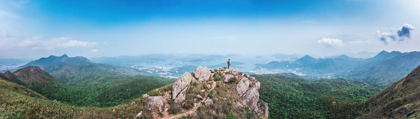 Obraz premium panorama of Man standing on the rock, hiking in Sai Kung, Hong Kong
