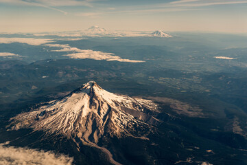 Ecuador is a country with many volcanoes. You can see at least three volcanoes on the flight to...