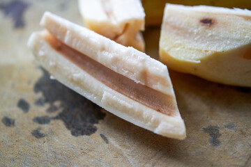 Close-up of a slice of fresh lotus root on a cutting board