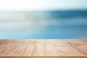 Wooden table and blurred sea background. Summertime and vacation