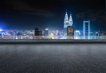 Kuala lumpur urban cityscape skyline night scene with empty asphalt floor on front. - Powered by Adobe