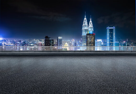 Fototapeta Kuala lumpur urban cityscape skyline night scene with empty asphalt floor on front.