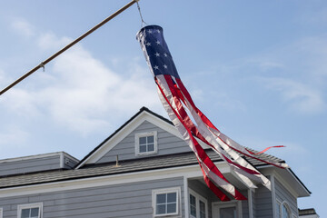 American flag windsock is seen hanging out in front of a house on the Balboa Island in Newport...