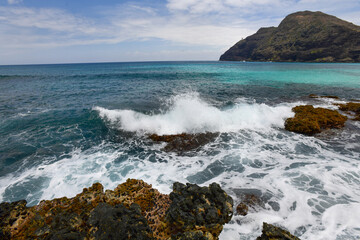 Waves crashing on rocks at Makapu'u Beach Park on the Ka'iwi Shoreline on Oahu, Hawaii.