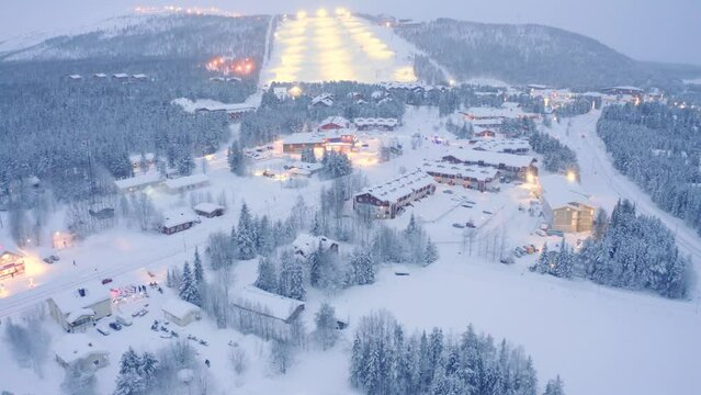 Drone aerial flyover closeup , Levi, Finland village snowy neighborhood with police incident crash on road