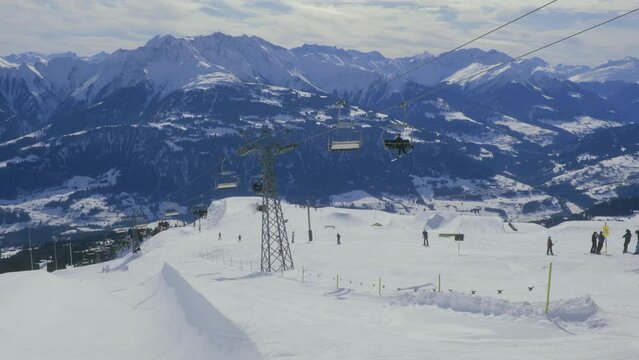 Crap Sogn Gion chairlift in Laax, Switzerland, from Caffe Noname, sunny day at ski resort